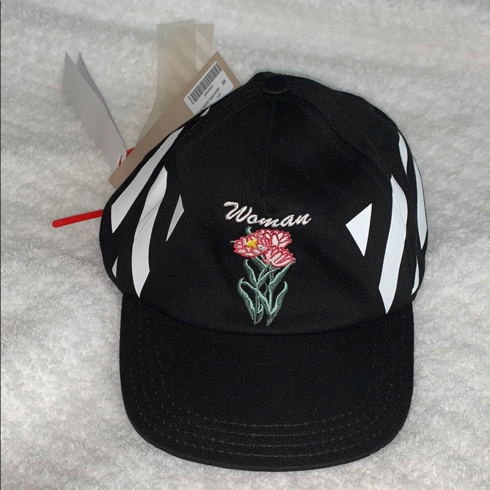 Black baseball cap with white stripes on side
